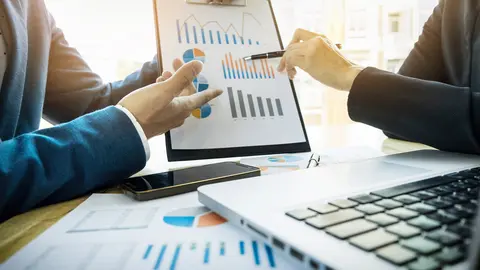 Team work process. young business managers crew working with new startup project. labtop on wood table, typing keyboard, texting message, analyse graph plans.